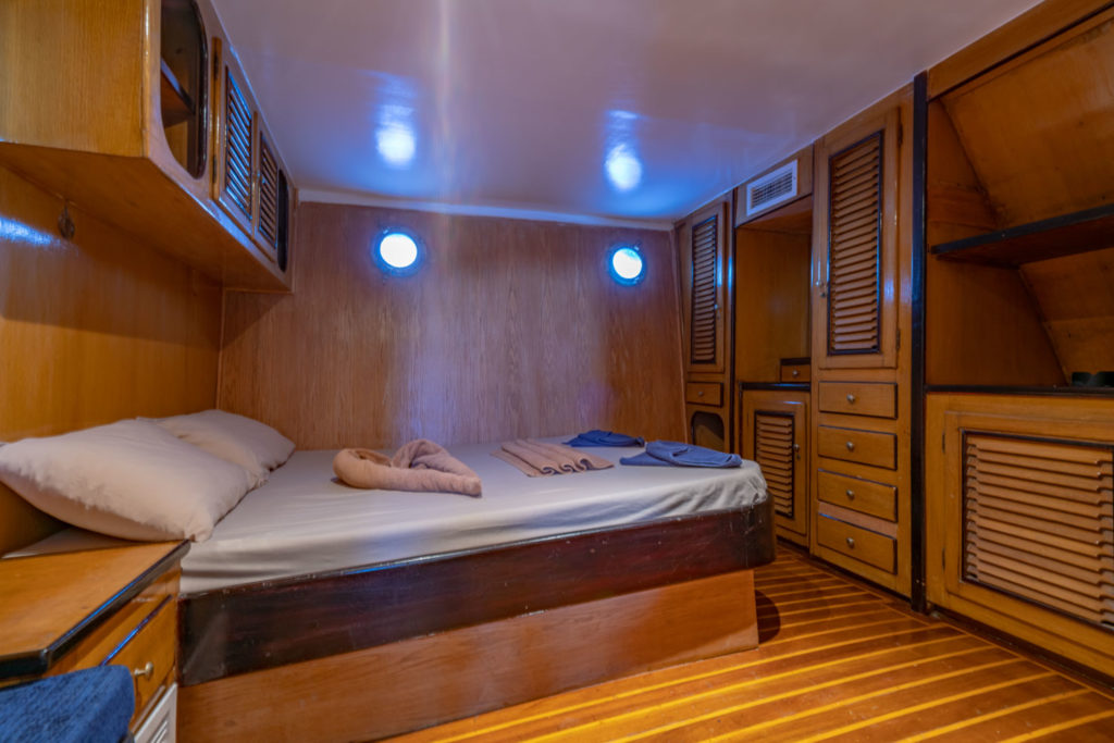Double cabin with wooden storage and portholes